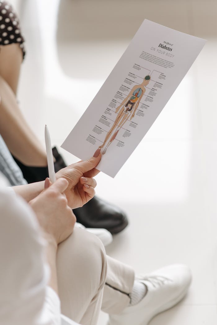 Hands holding a diabetes information sheet highlighting awareness and education.